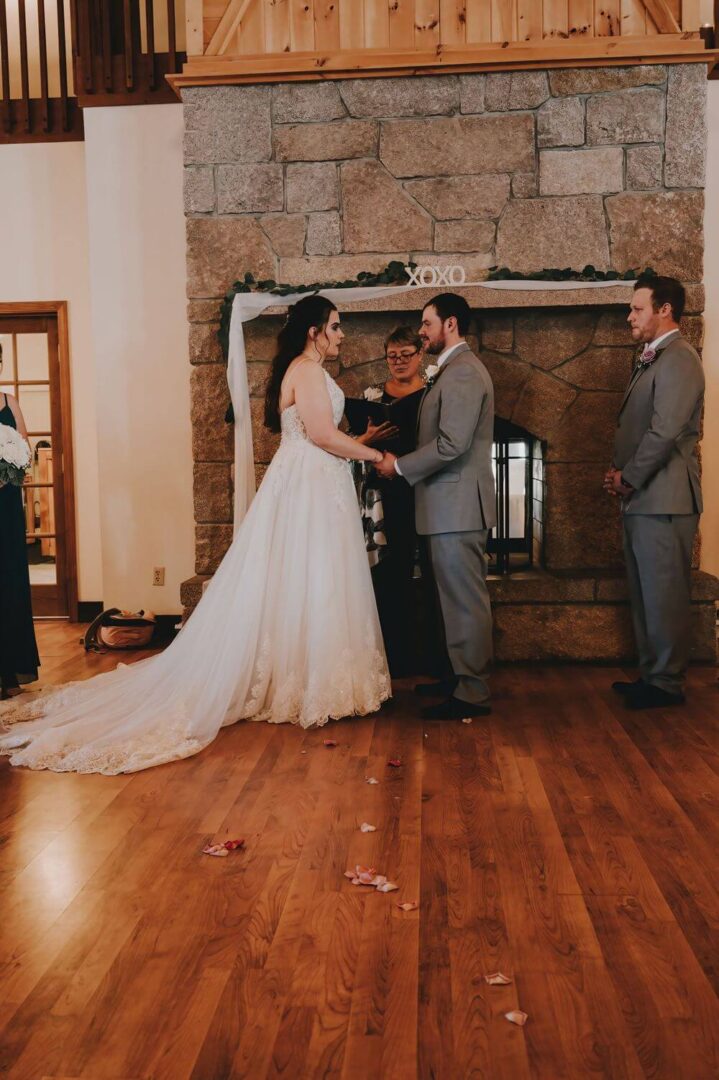 A couple getting married in front of two men.