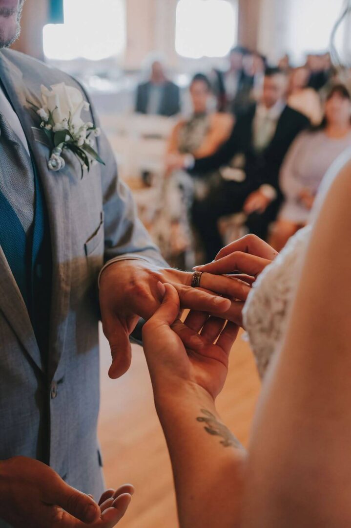 A man and woman exchanging rings at their wedding.