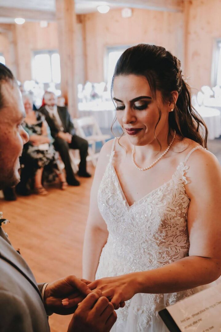 A bride and groom are holding hands in front of the crowd.