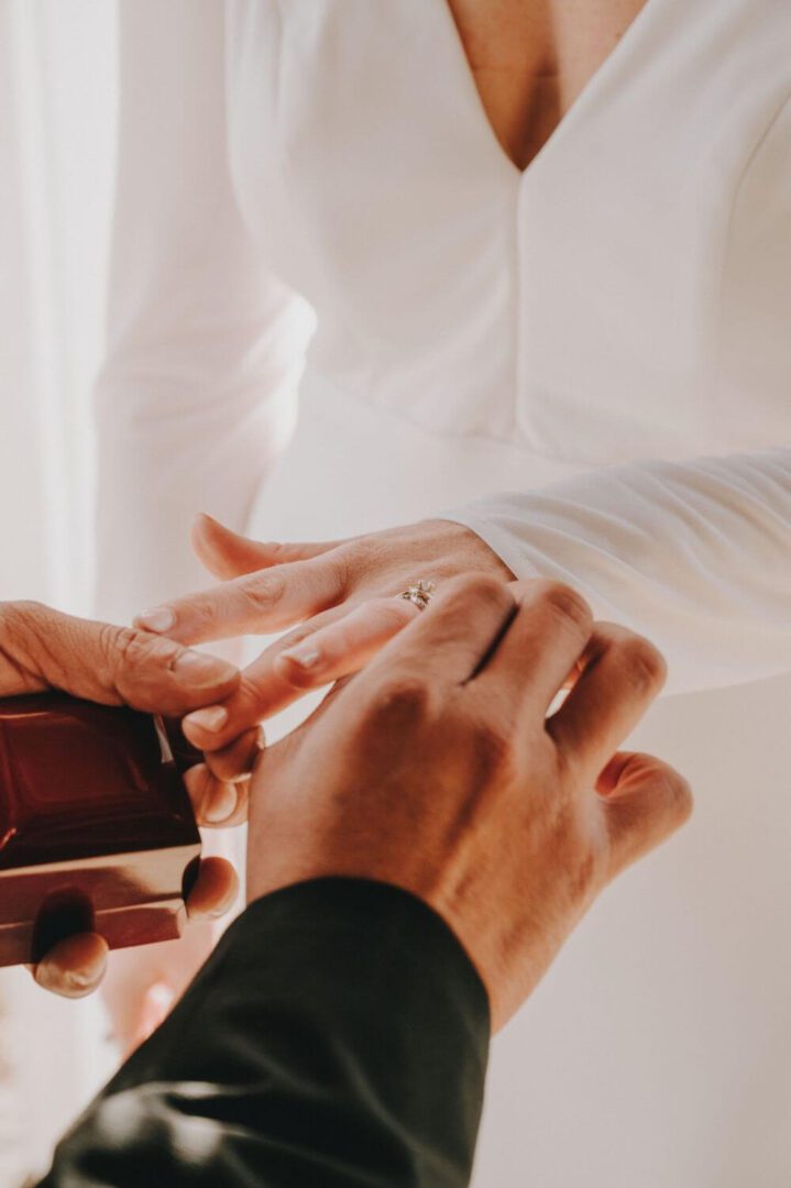 A man putting his wedding ring on another mans finger