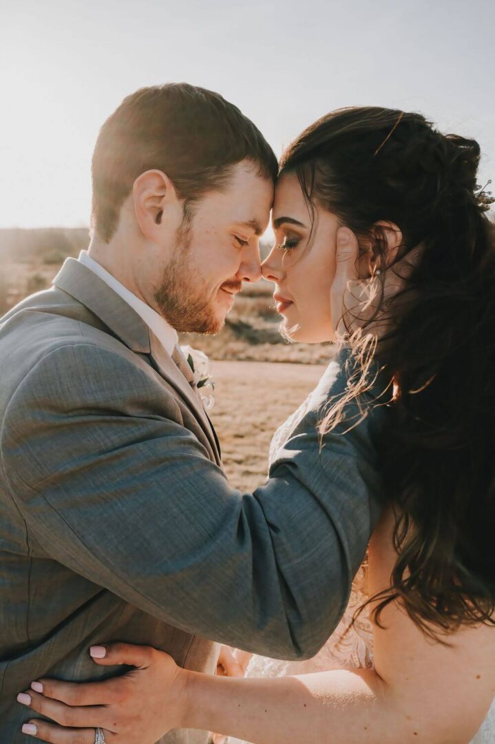 A man and woman embracing each other in the desert.