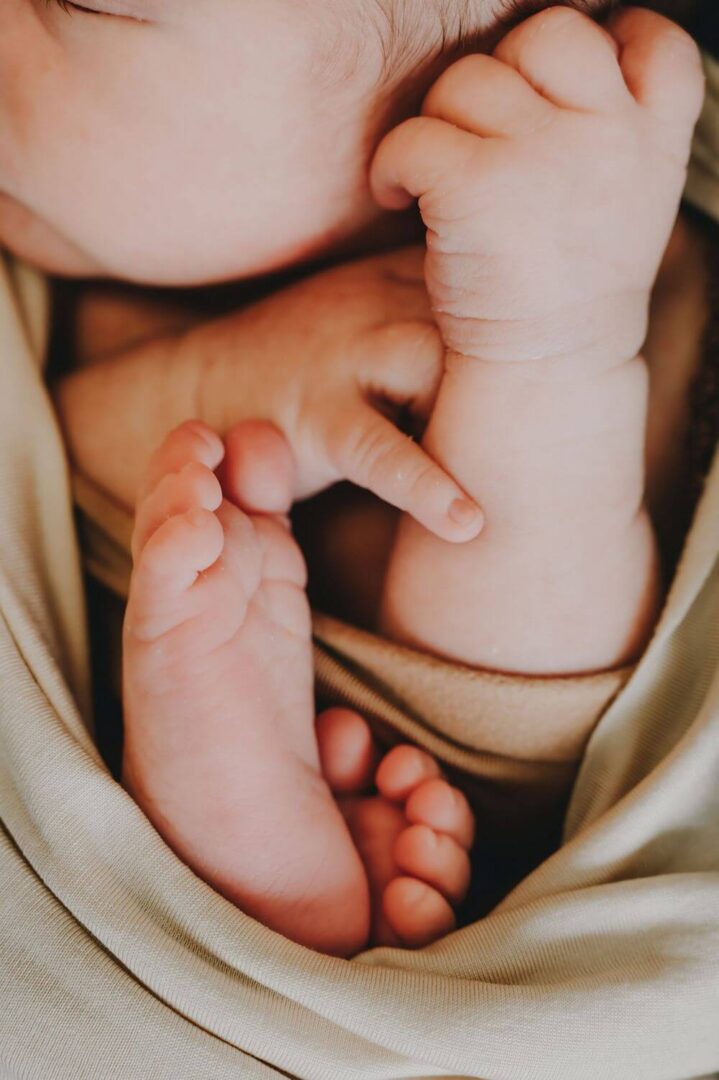 A baby 's feet are shown in the air.