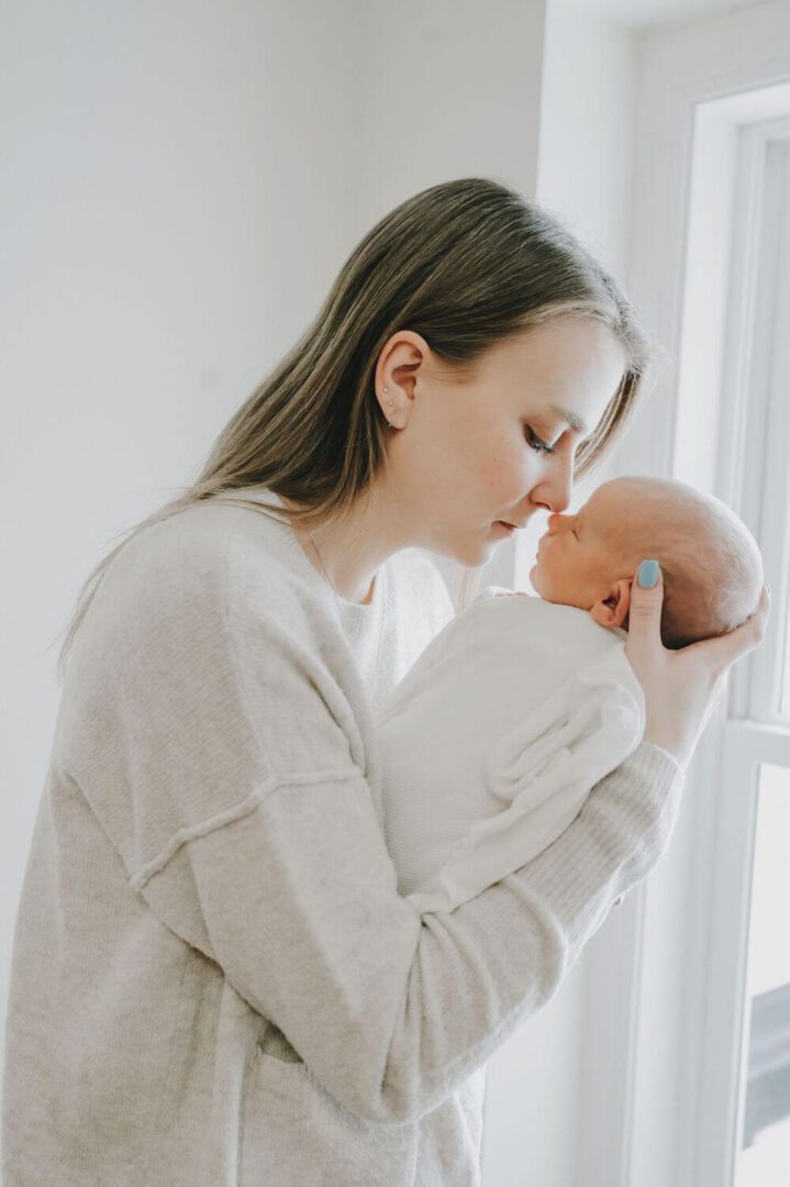 A woman holding a baby in her arms.