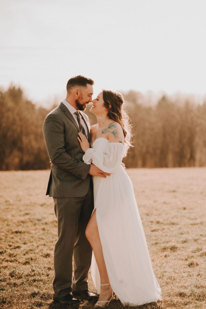 A man and woman standing in the middle of a field.