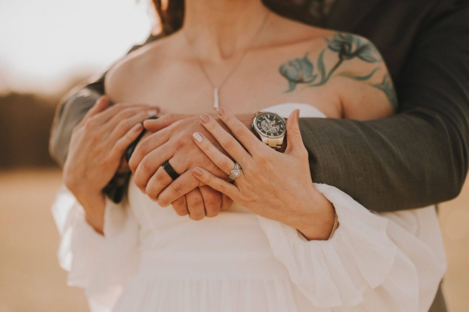 A woman holding her hands around the chest of another person.