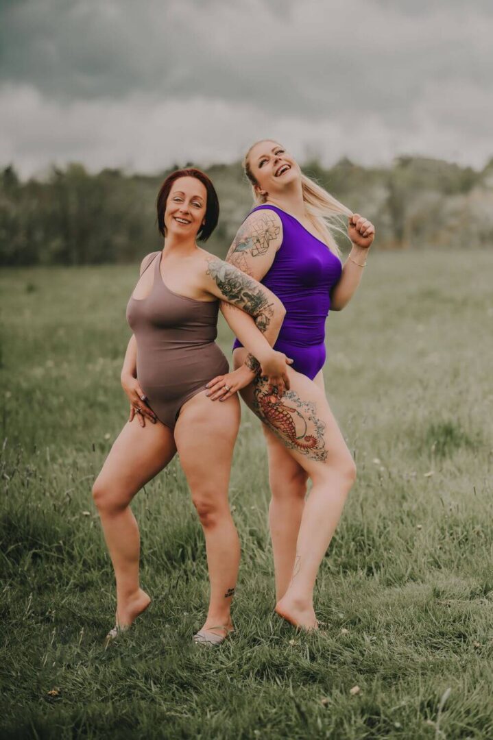 Two women in bathing suits standing next to each other.